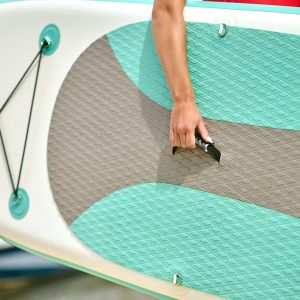 Surfing. Close up picture of a person carrying the surfing board